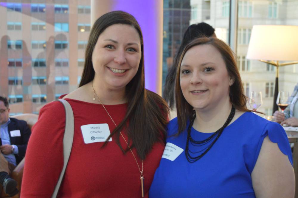 Two alumnae smile for a photo together at the Chicago Alumni Reception